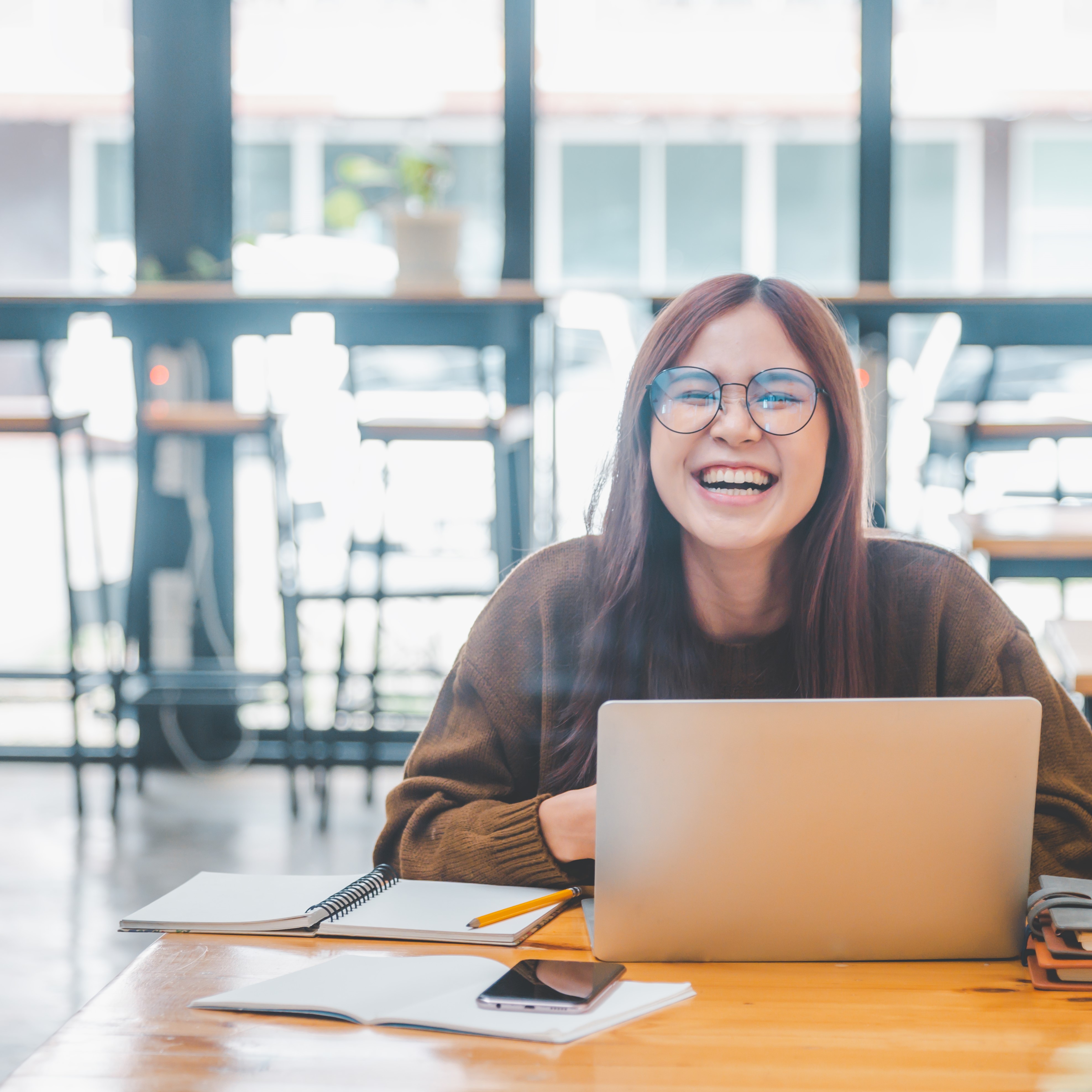 Smiling student working at laptop